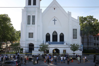 CHARLESTON, SC - JUNE 18:  People stand outside the Emanuel AME Church after a mass shooting at the church that killed nine people on June 18, 2015, in Charleston, South Carolina. A 21-year-old suspect, Dylann Roof of Lexington, South Carolina, was arrersted Thursday during a traffic stop. Emanuel AME Church is one of the oldest in the South. (Photo by Joe Raedle/Getty Images)