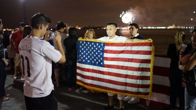 Immigrant with American flag July 4 2015
