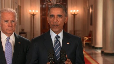 President Obama praises a nuclear deal with Iran as Vice President Biden looks on at the White House.