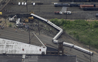 Emergency personnel work at the scene of a deadly train derailment, Wednesday, May 13, 2015, in Philadelphia. The Amtrak train, headed to New York City, derailed and crashed in Philadelphia on Tuesday night, killing at least six people and injuring dozens of others. (AP Photo/Patrick Semansky)